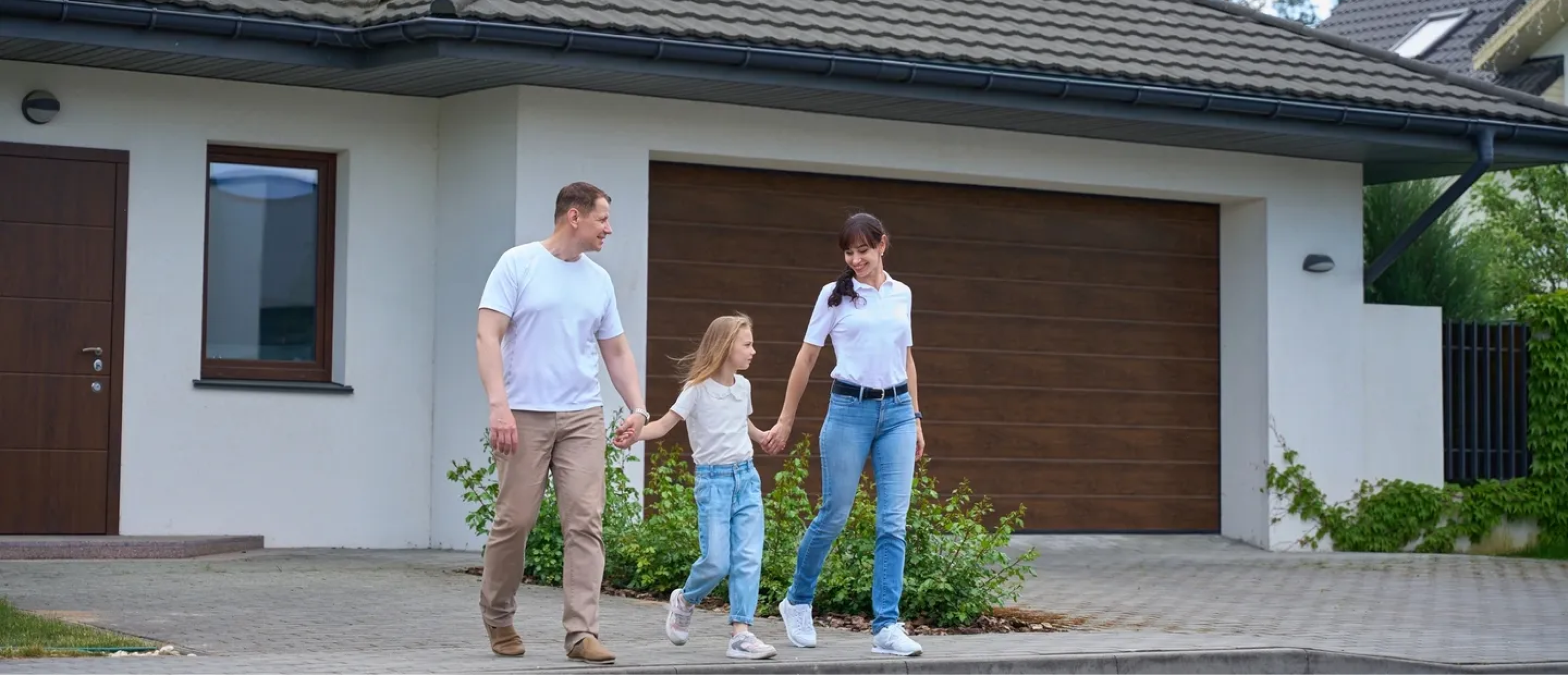 Family walking in front of their house.